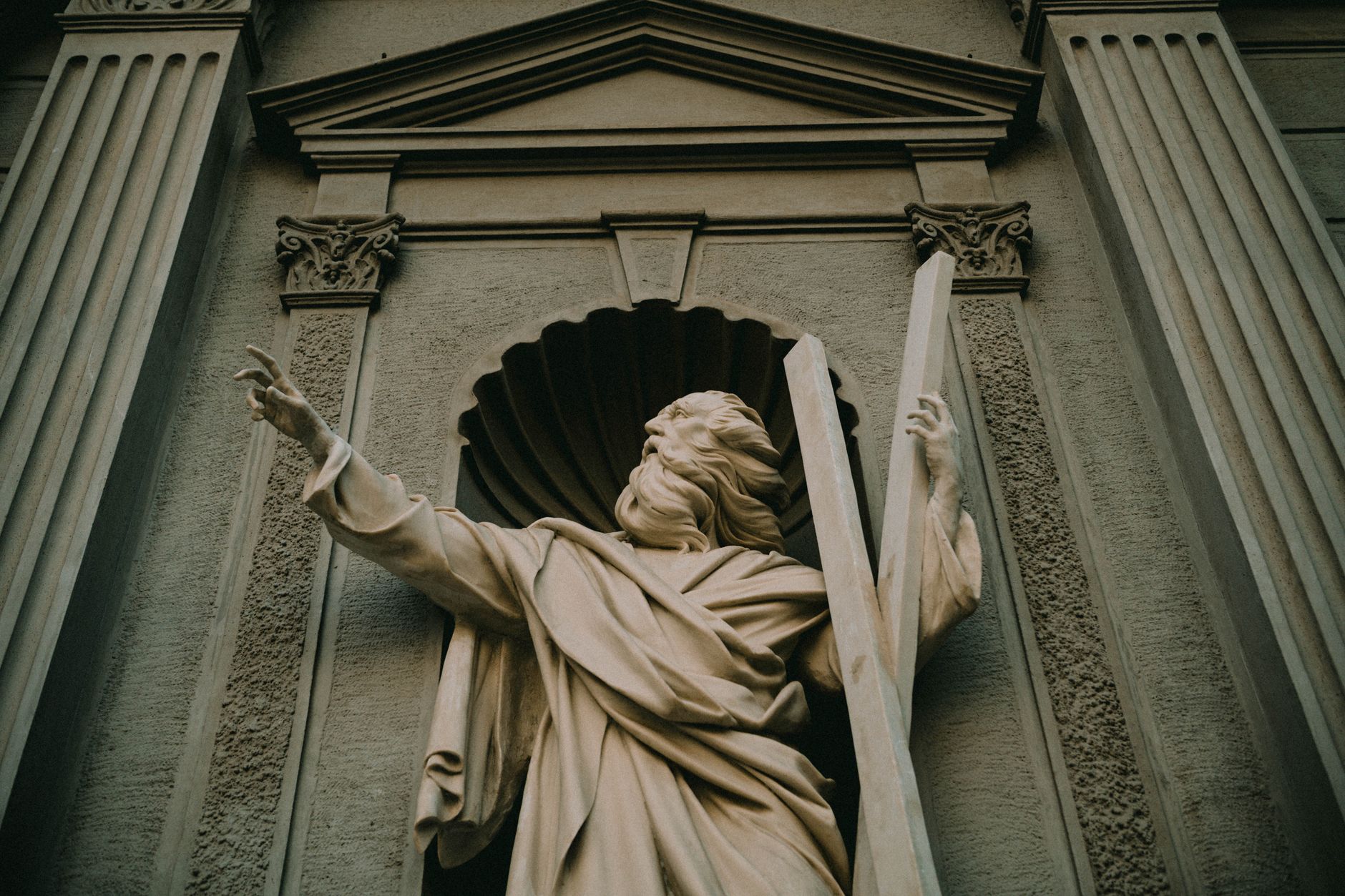 classical statue on historic building facade