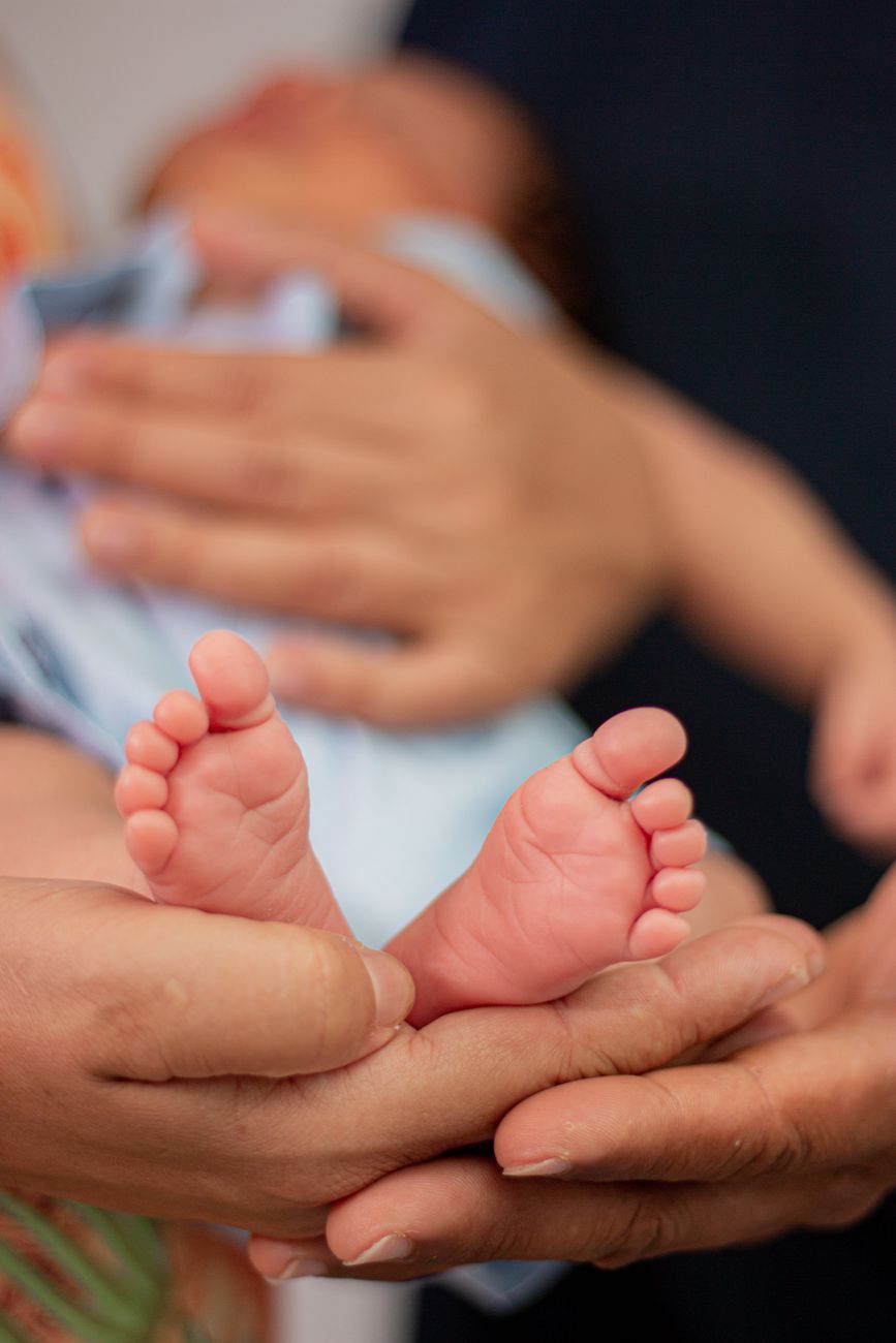 baby feet on hands