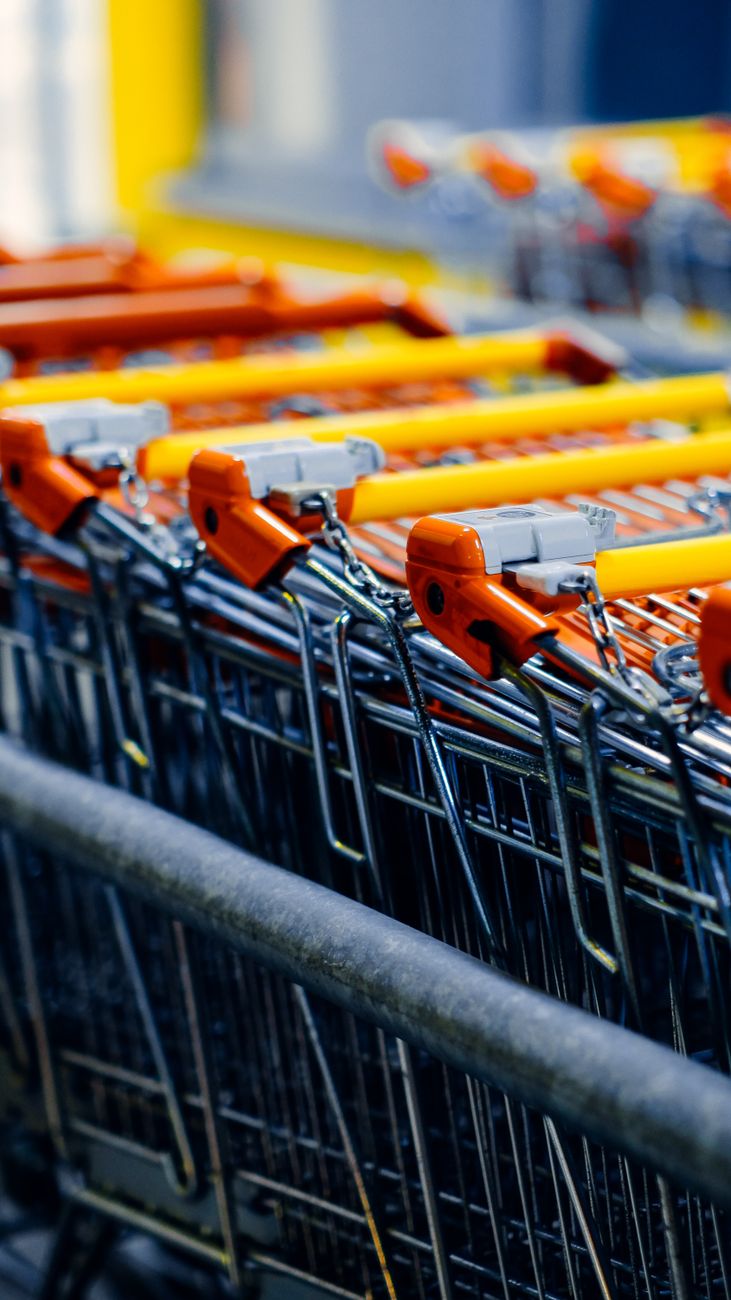 row of shopping carts with orange handles