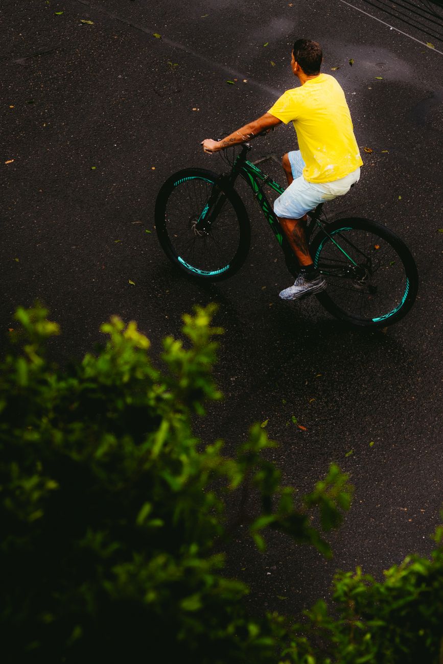 bird s eye view of cyclist on wet road