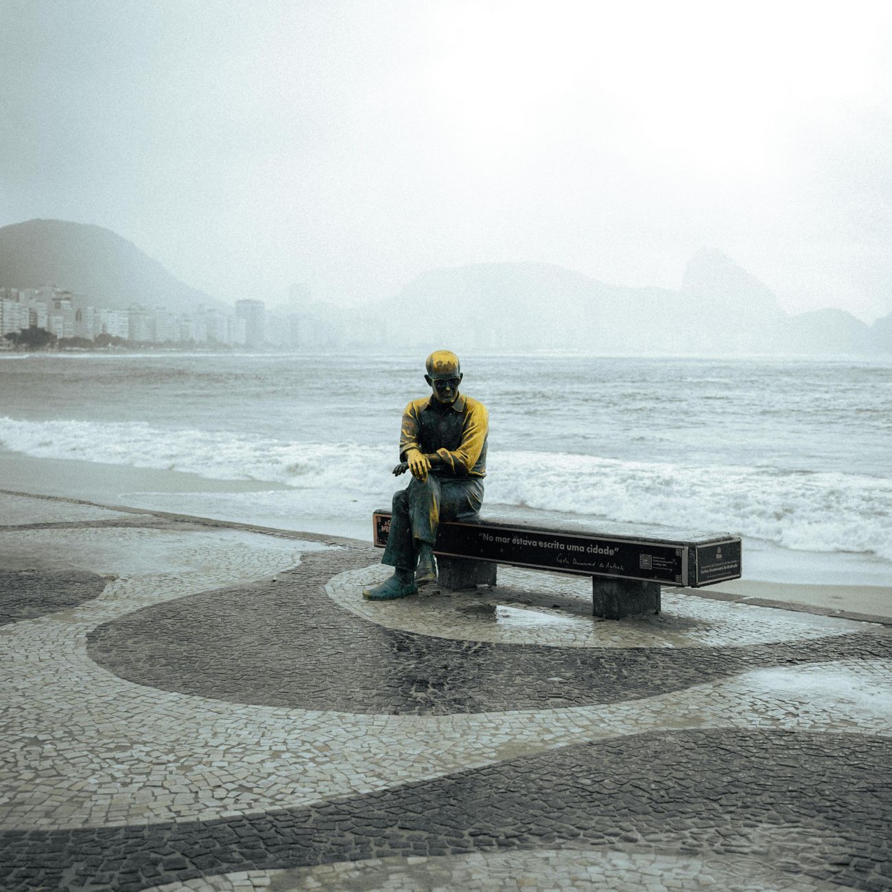 statue on copacabana beach amidst overcast